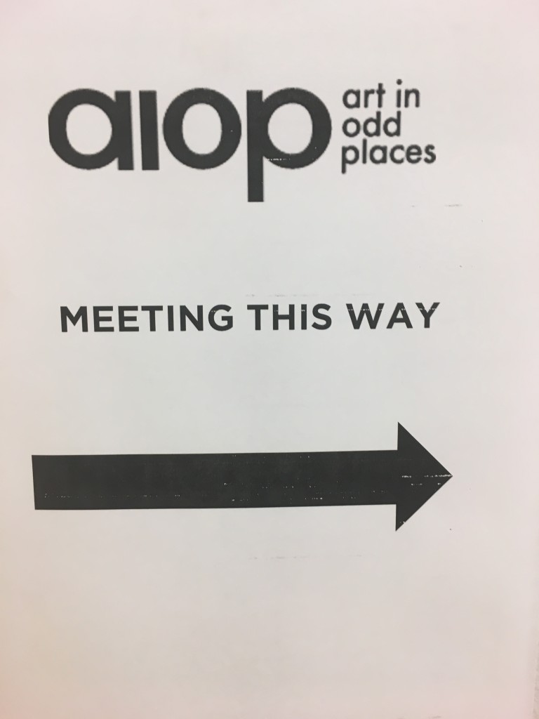 Sign pointing to the meeting location.